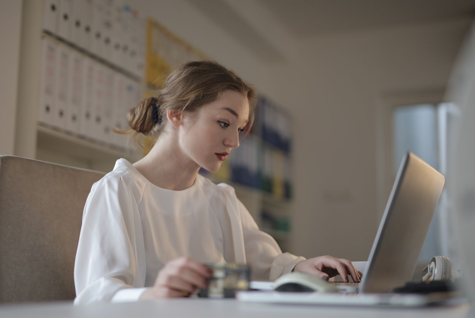 Bookkeeper reviewing spreadsheet on a laptop